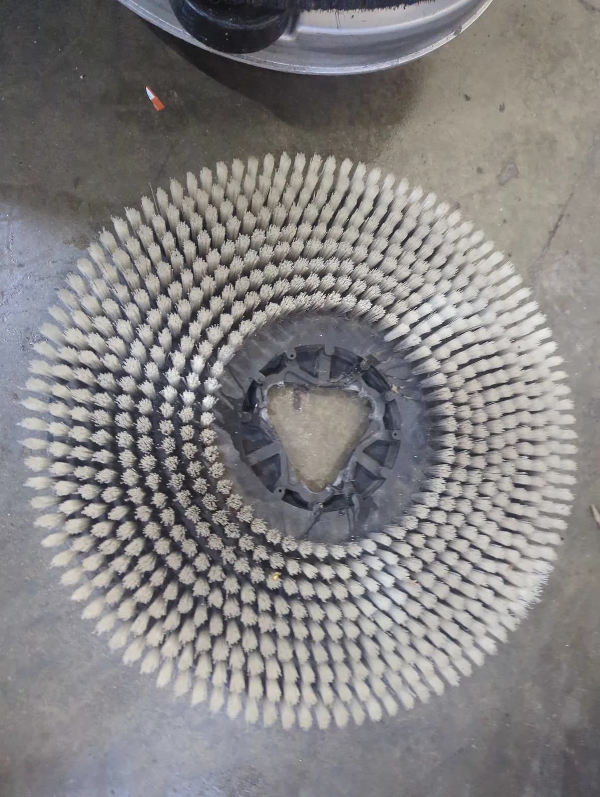 Scrub brush pad inspected during a preventive maintenance visit