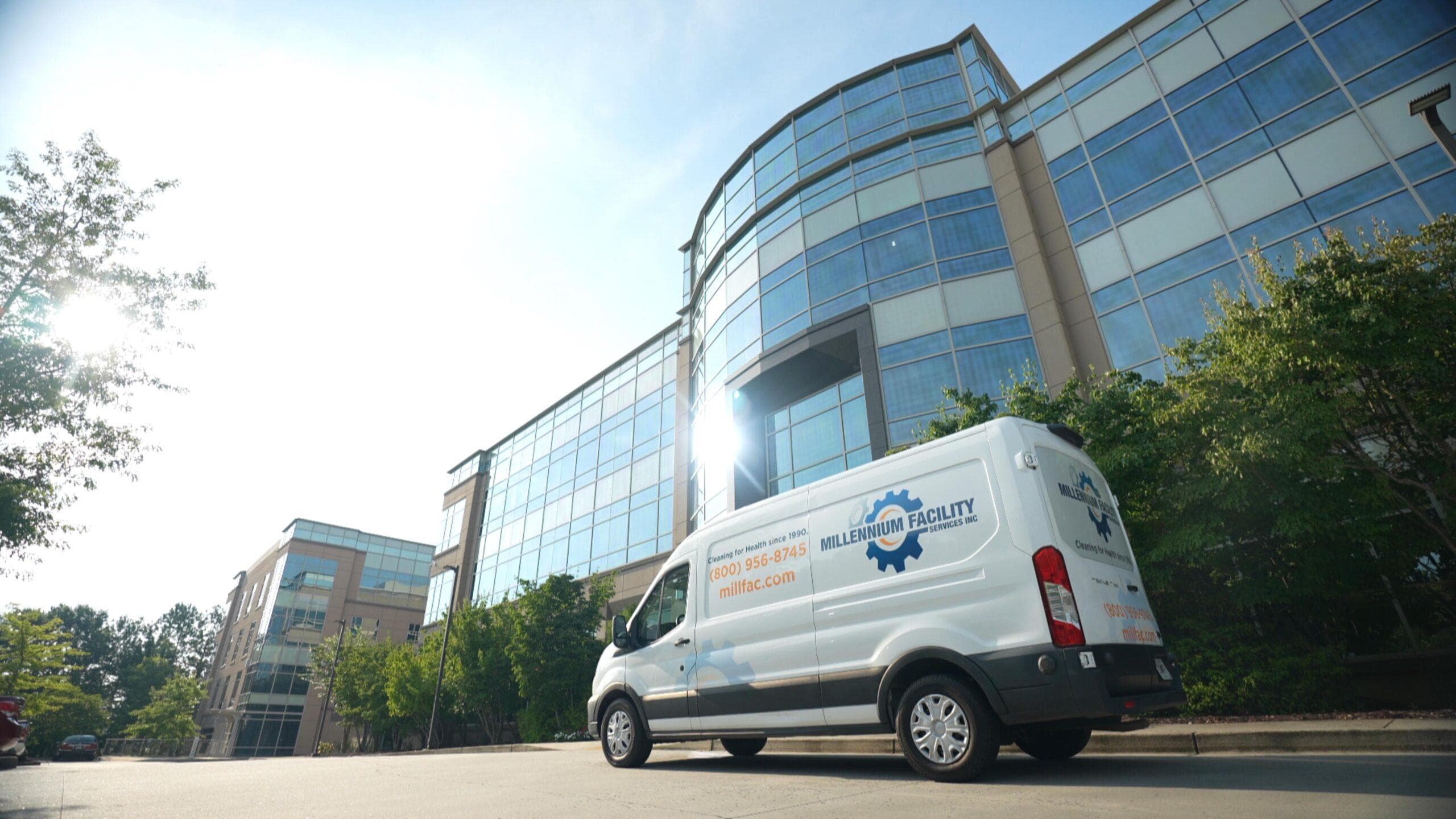 Millennium Facility Services van outside a corporate office building
