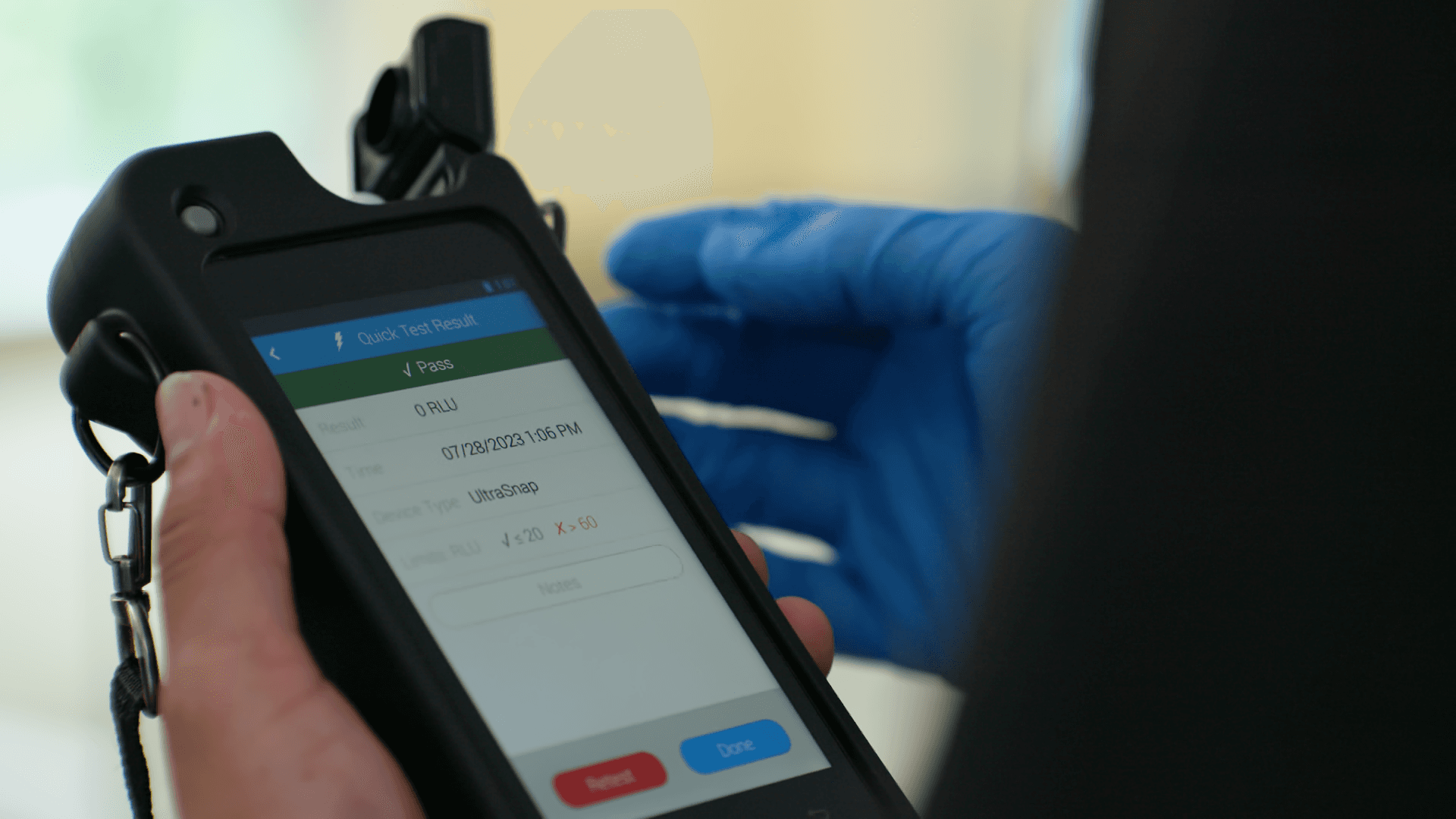 Technician using digital inspection device with blue gloves in a medical facility